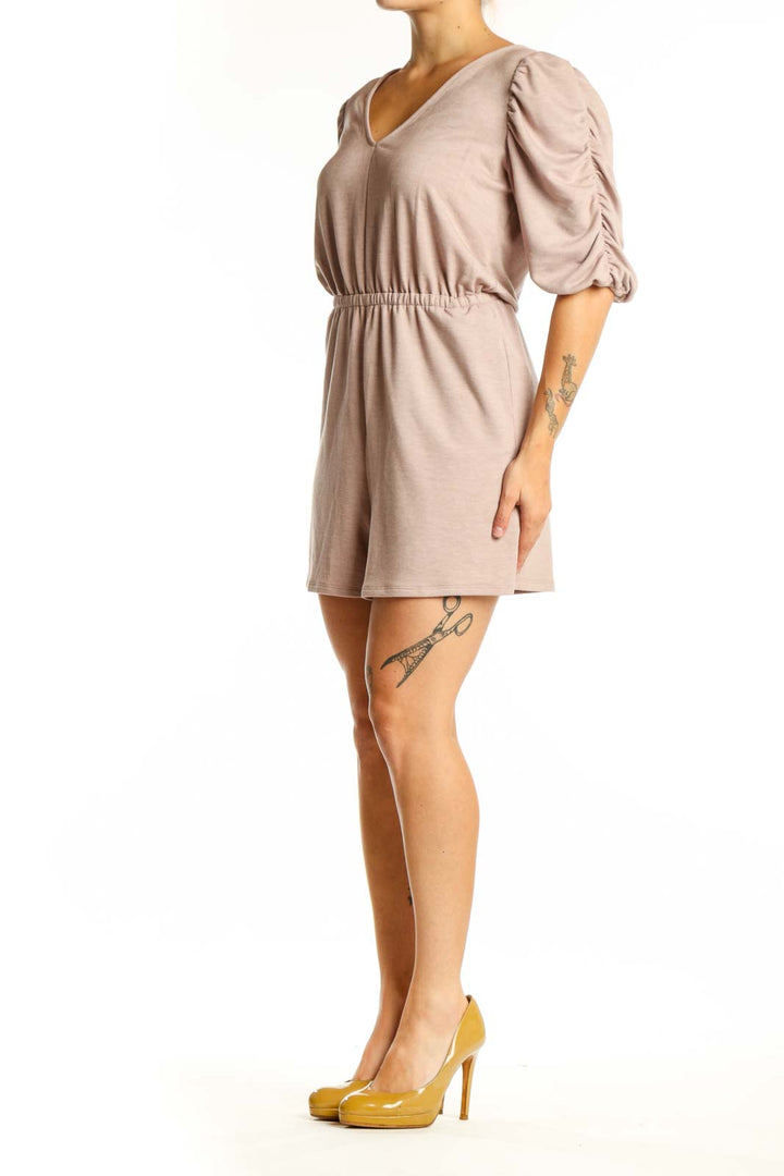Beige puff sleeve romper with V-neckline and cinched waist, front view