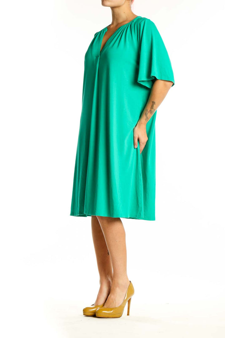 Front view of teal rayon A-line shift dress with V-neckline and gathered shoulder details