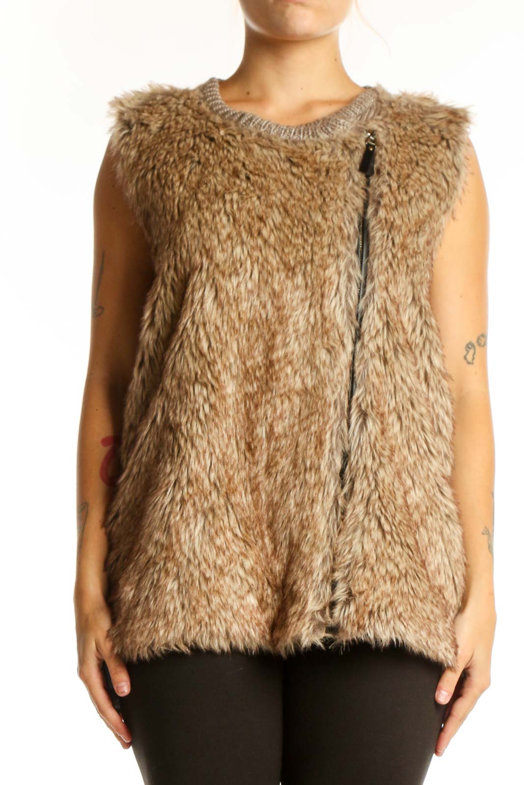 Beige fuzzy knit vest with crew neckline and front zipper, worn with black pants