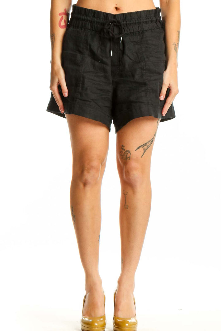 Black drawstring athletic shorts with elastic waistband and side pockets, front view