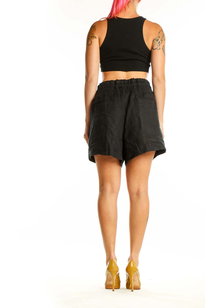 Black drawstring athletic shorts with functional pockets, back view
