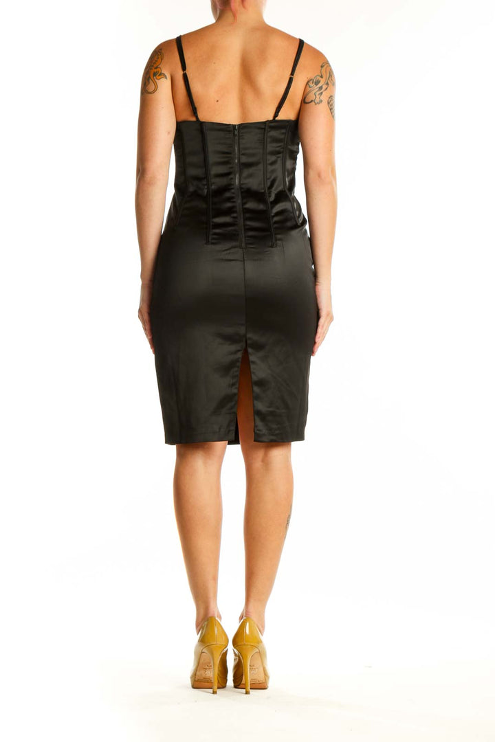 Back view of black lace camisole cocktail dress showing adjustable straps and tailored silhouette