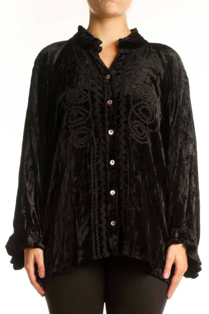 Black crushed velvet button-up blouse with ruffled collar and gathered sleeves, front view