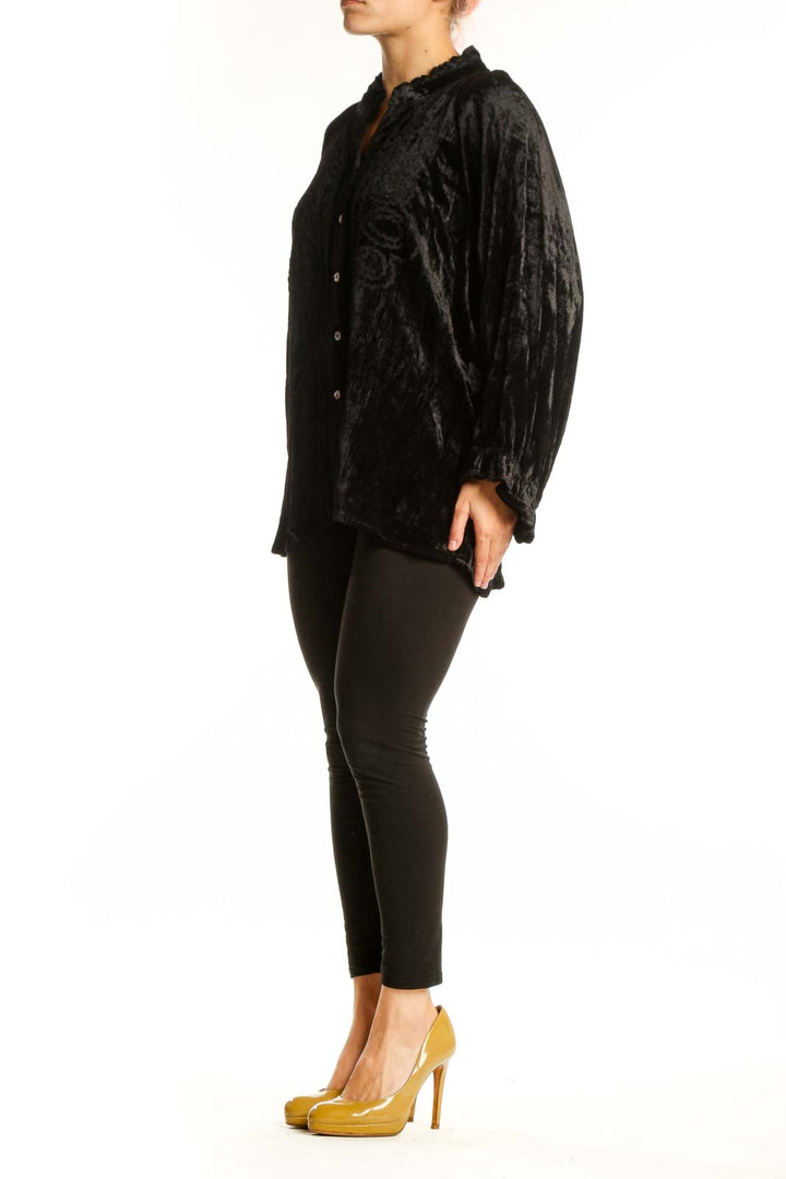 Black crushed velvet button-up blouse with ruffled collar and gathered sleeves, front view