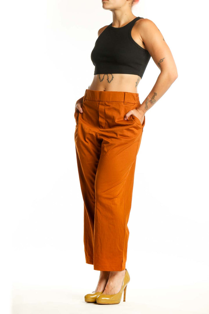 Front view of orange cropped polyester pants by Lands' End, size L, featuring high-waisted design and modern silhouette