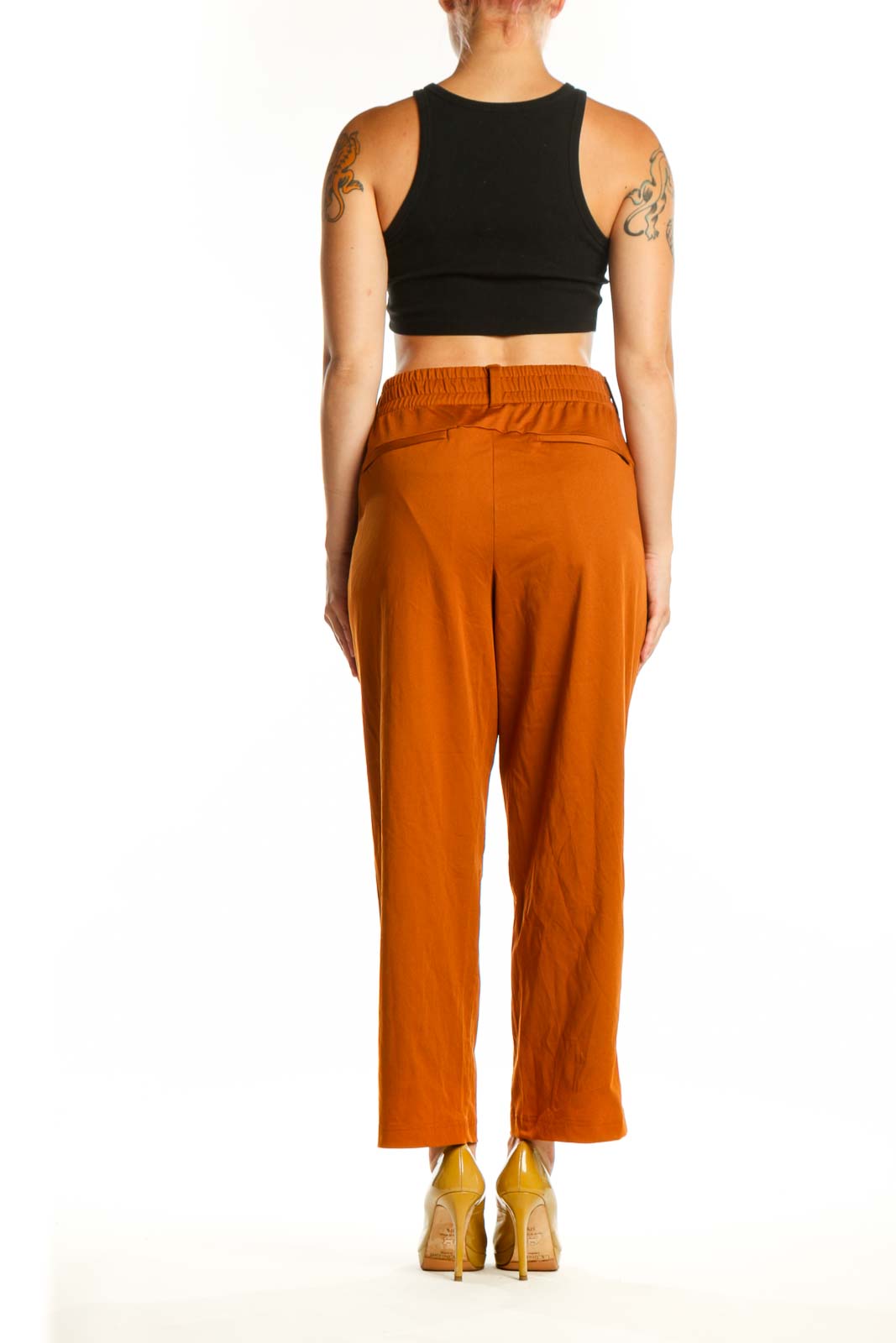 Back view of orange cropped polyester pants by Lands' End showing fit and length, paired with black crop top