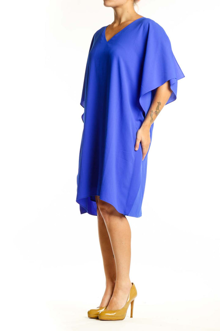 Blue V-neck caftan dress with flutter sleeves and asymmetrical hemline, front view