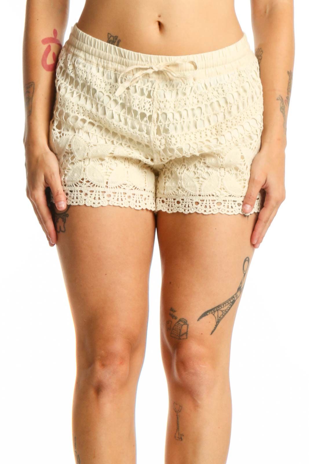 Cream lace shorts with crochet design and drawstring waist, front view on model