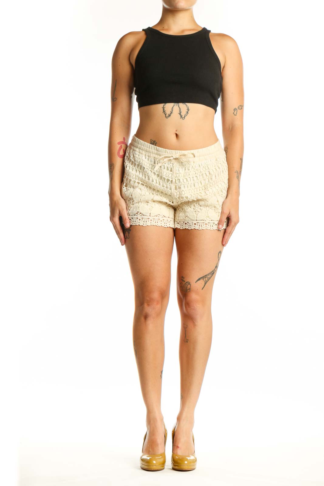 Cream lace shorts with crochet design and drawstring waist, front view on model