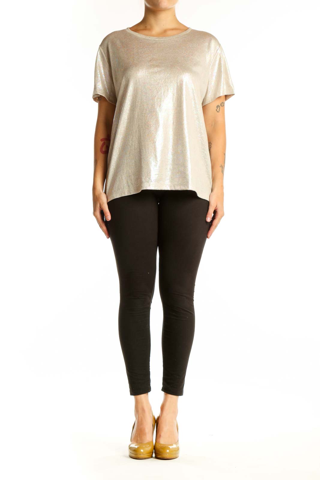 Gold metallic short sleeve top with crew neckline, front view on model wearing black leggings