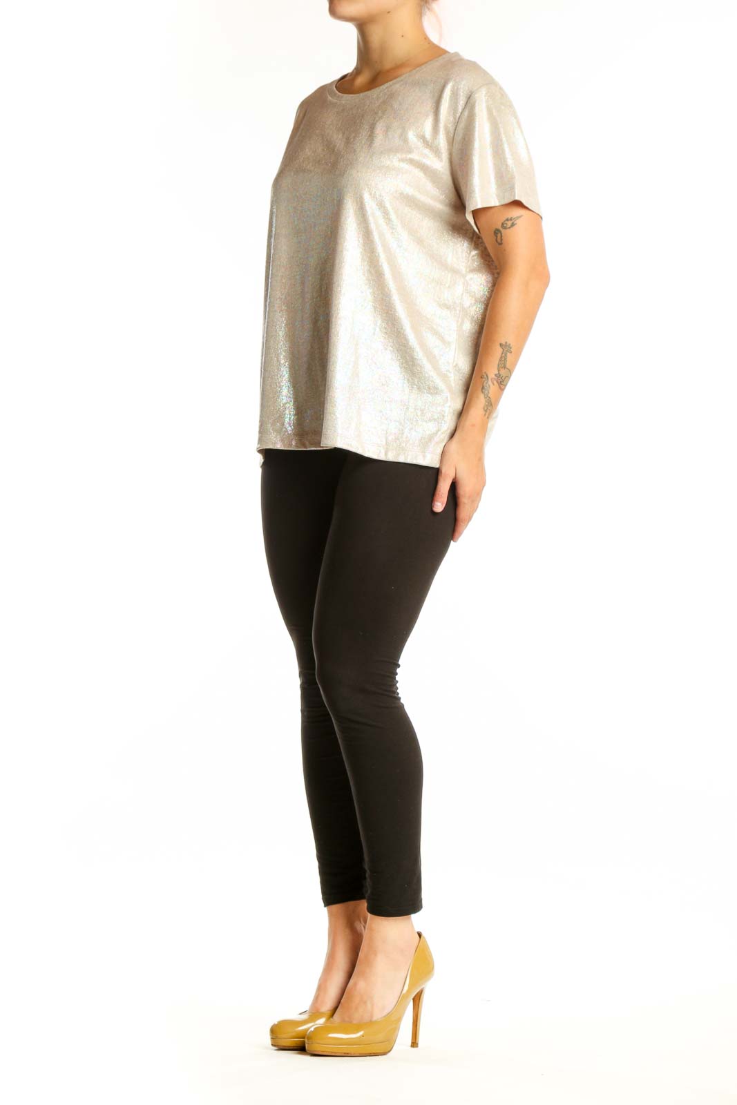 Gold metallic short sleeve top with crew neckline, front view on model wearing black leggings
