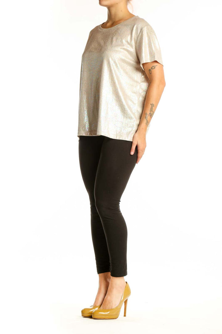 Gold metallic short sleeve top with crew neckline, front view on model wearing black leggings