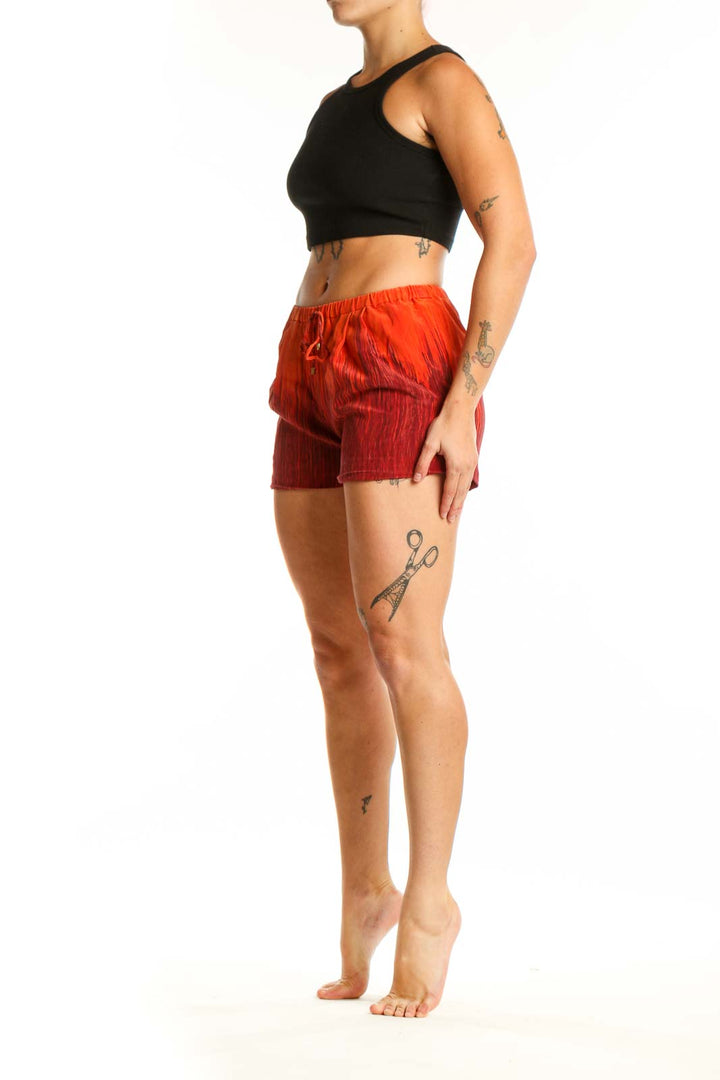 Red ombré silk shorts with drawstring waist, front view on model
