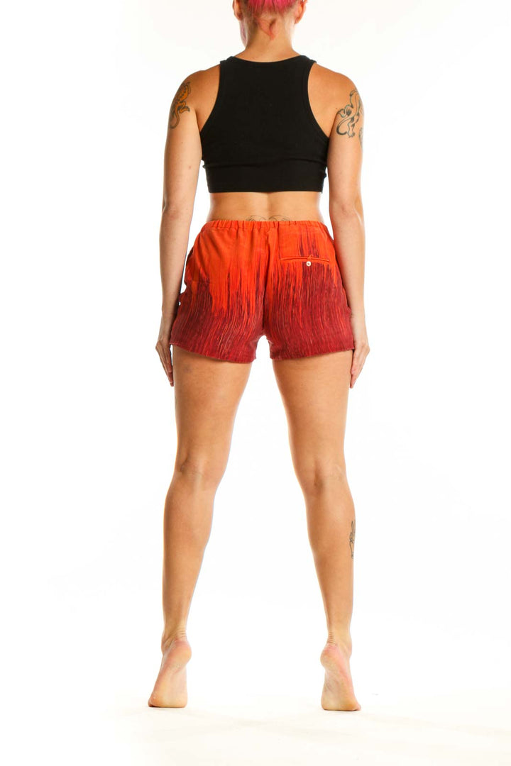 Red ombré silk shorts with drawstring waist, back view on model