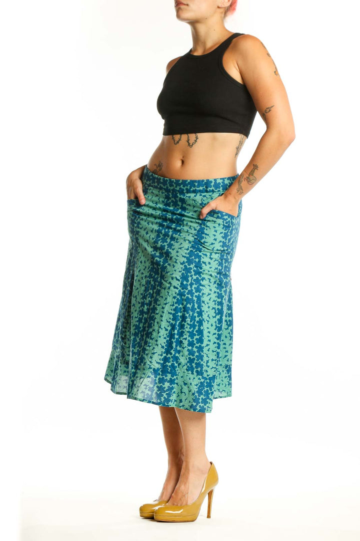Teal and mint green floral A-line cotton skirt by Marc Jacobs, front view showing botanical print and midi length