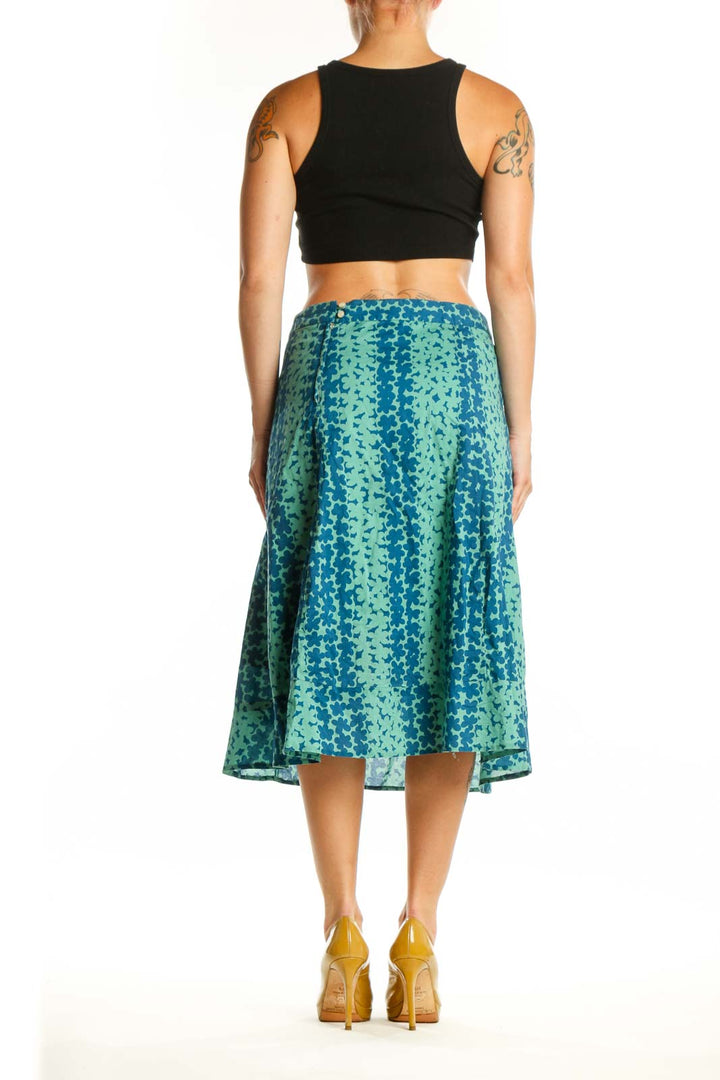 Back view of Marc Jacobs teal floral A-line cotton skirt displaying elegant drape and botanical pattern