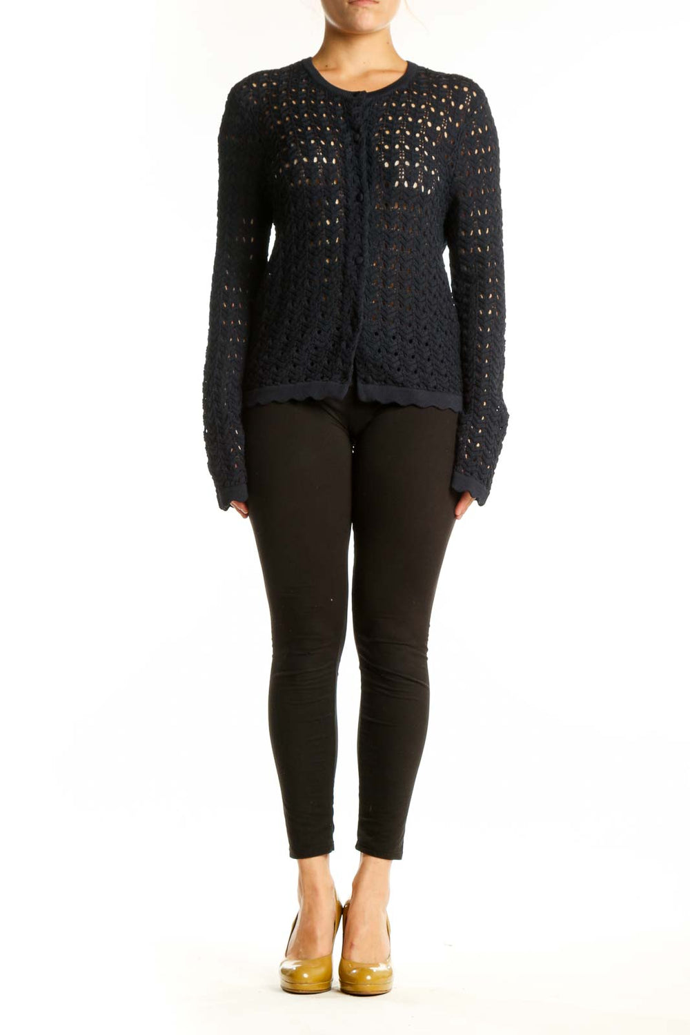 Black openwork knit cardigan with button-front closure and long sleeves, worn with black pants