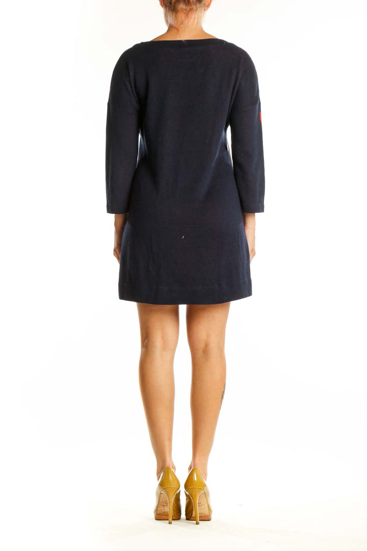 Navy knit dress with pink floral pattern, back view showing artistic botanical motif design
