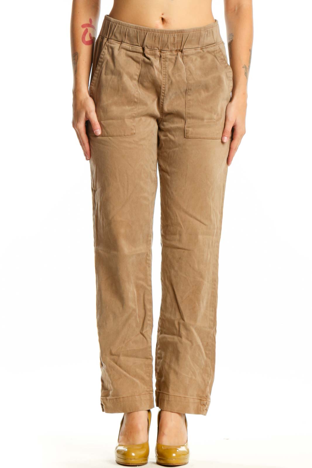 Beige cargo pants with elastic waistband and functional pockets, front view on model