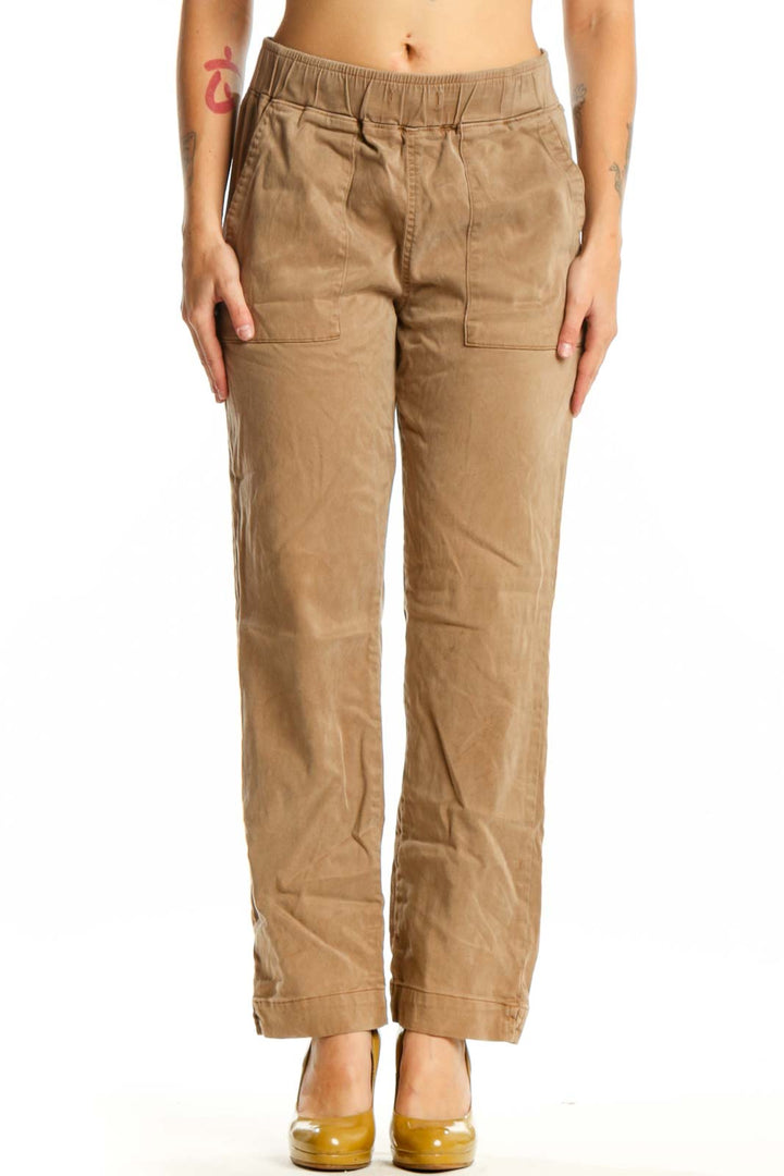 Beige cargo pants with elastic waistband and functional pockets, front view on model