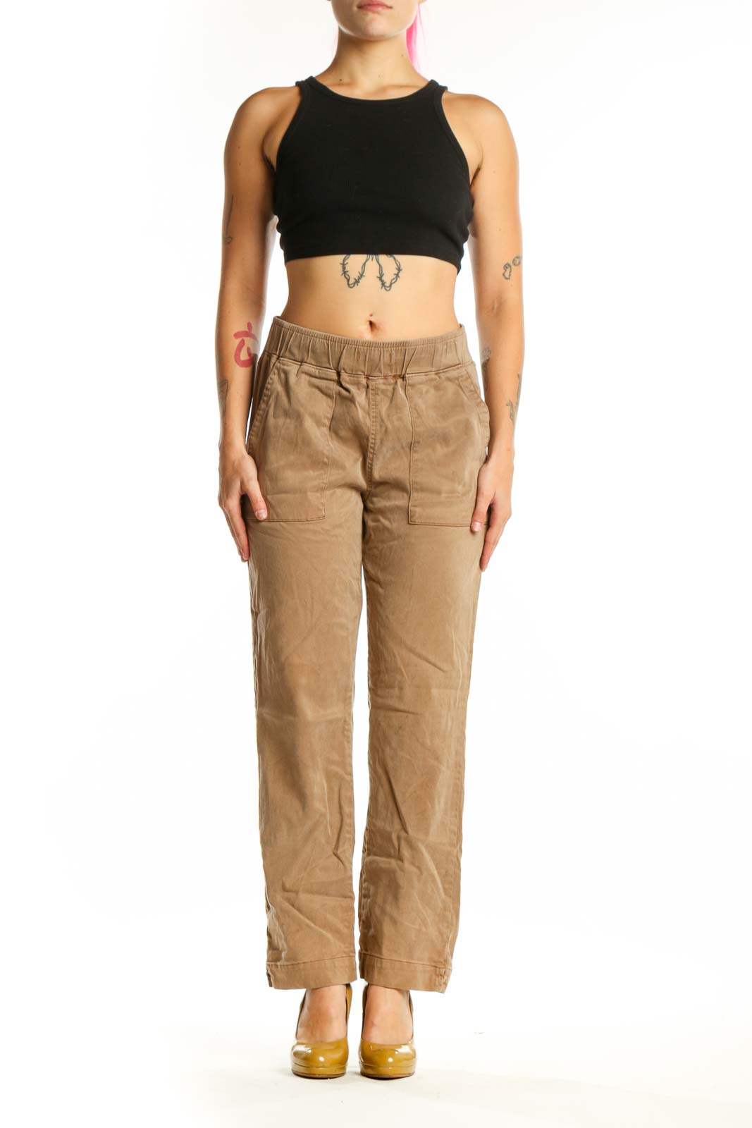 Beige cargo pants with elastic waistband and functional pockets, front view on model