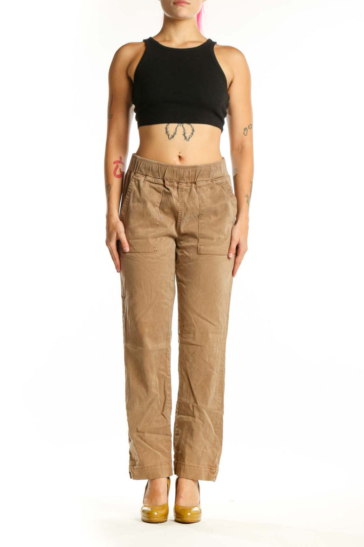 Beige cargo pants with elastic waistband and functional pockets, front view on model