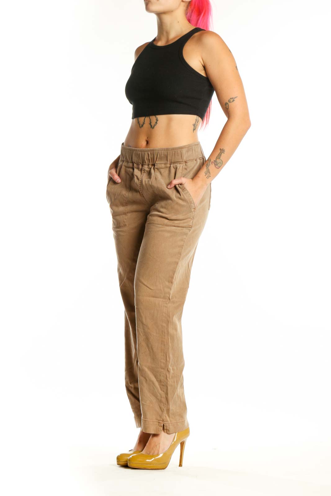 Beige cargo pants with elastic waistband and functional pockets, front view on model