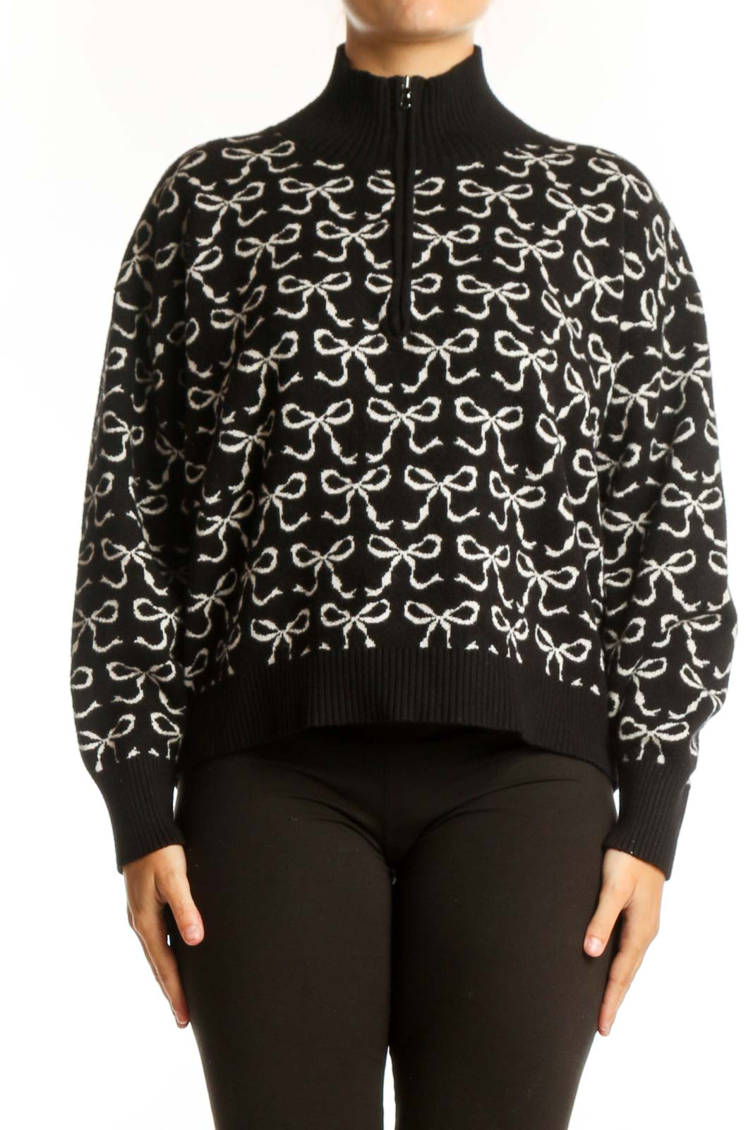 Black pullover knit with cream bow print pattern, half-zip neckline, and ribbed collar by Maeve