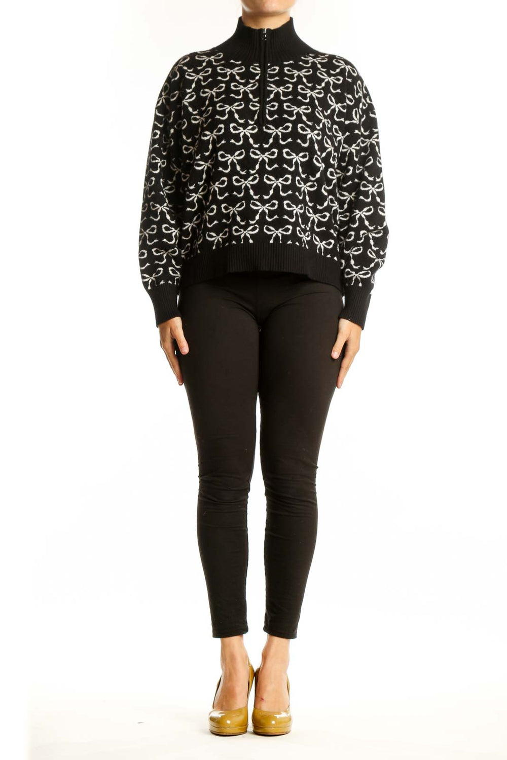 Black pullover knit with cream bow print pattern, half-zip neckline, and ribbed collar by Maeve