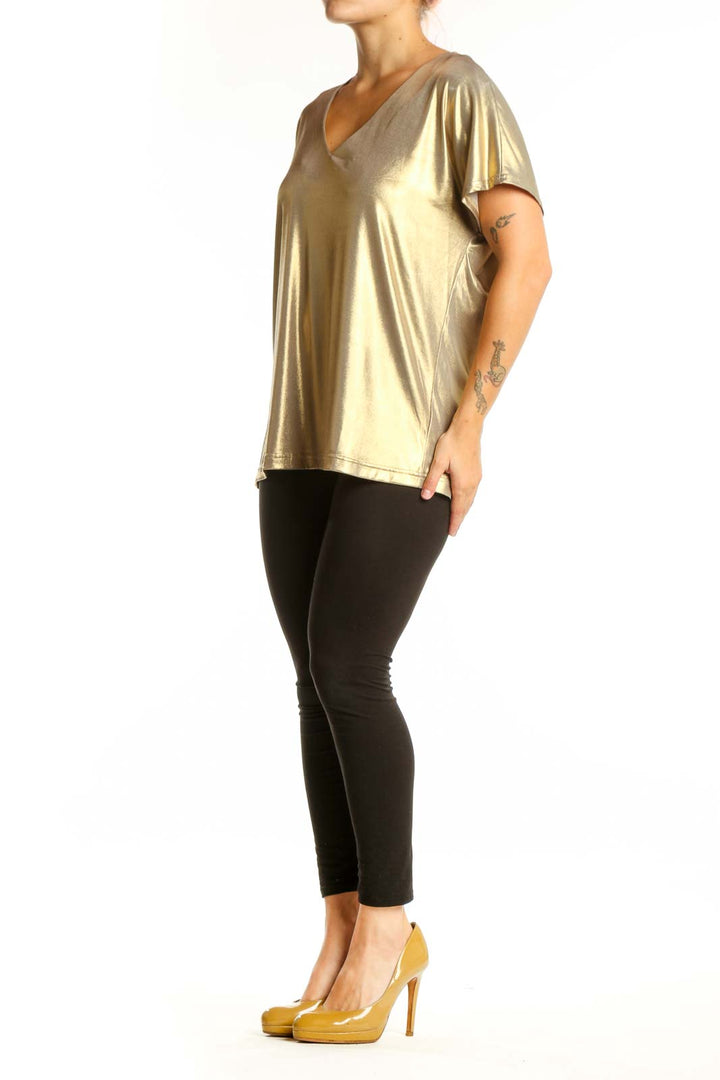 Gold metallic v-neck short sleeve top with stretch fabric, front view on model