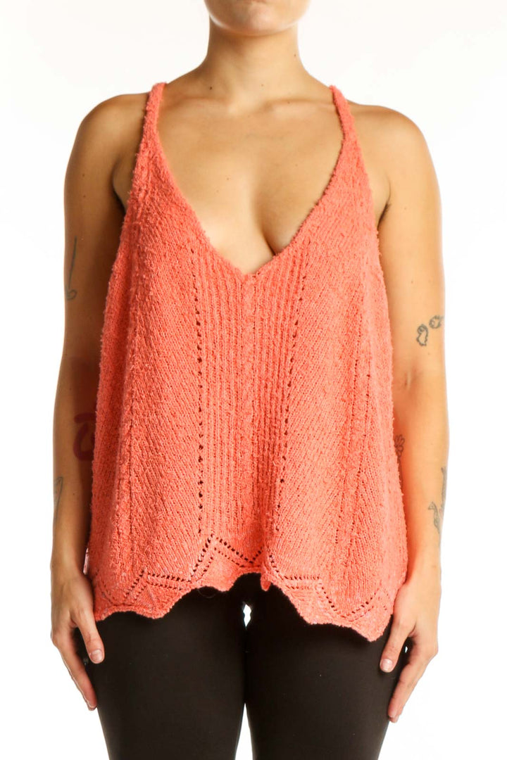 Coral knit tank top with V-neckline and scalloped hem, front view on model