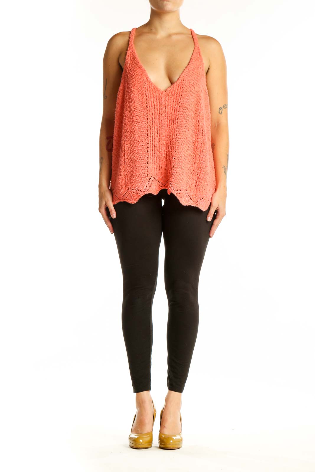 Coral knit tank top with V-neckline and scalloped hem, front view on model