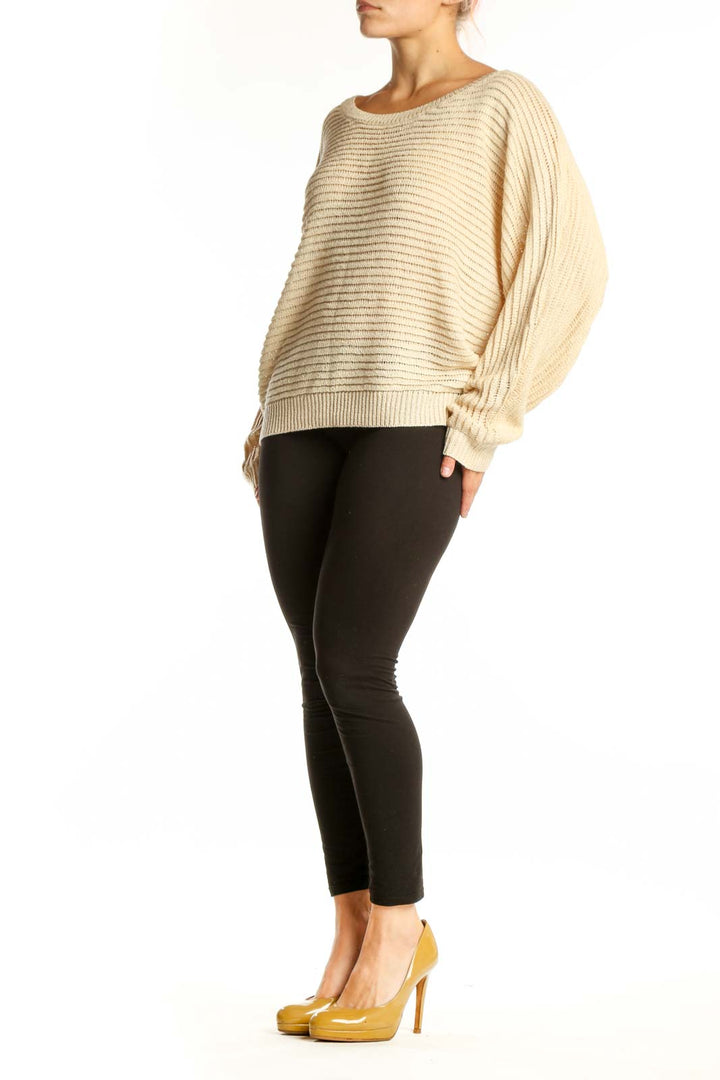 Cream ribbed knit sweater with balloon sleeves and oversized fit, front view