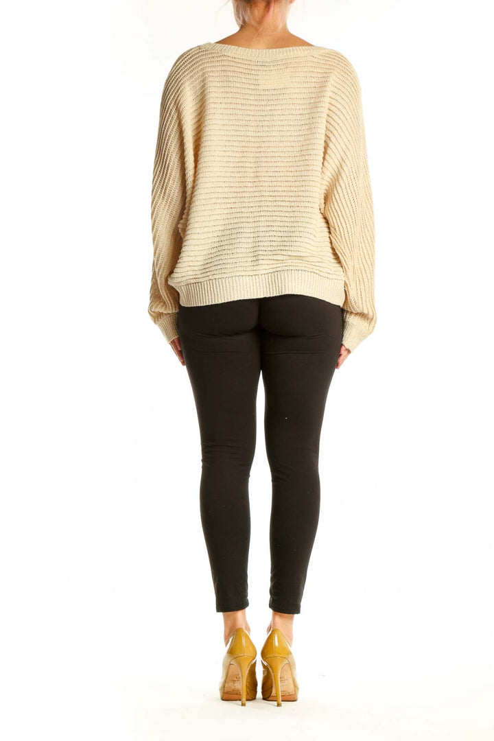 Cream ribbed knit sweater with balloon sleeves, back view showing relaxed silhouette