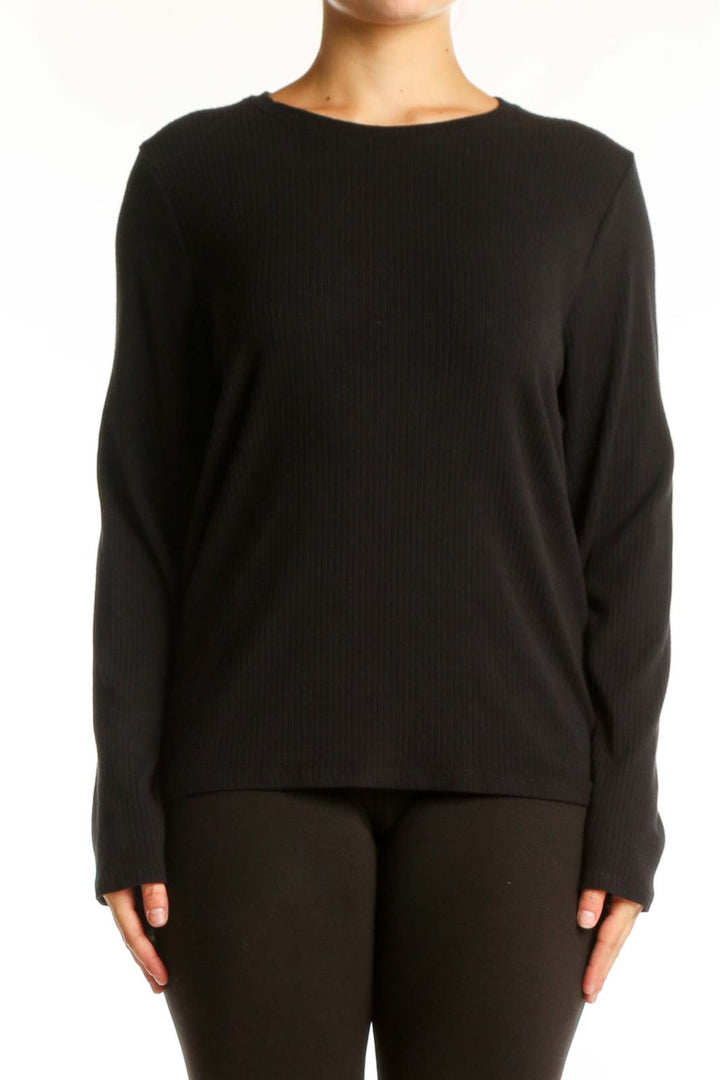 Black ribbed knit long sleeve top with crew neckline, front view on model