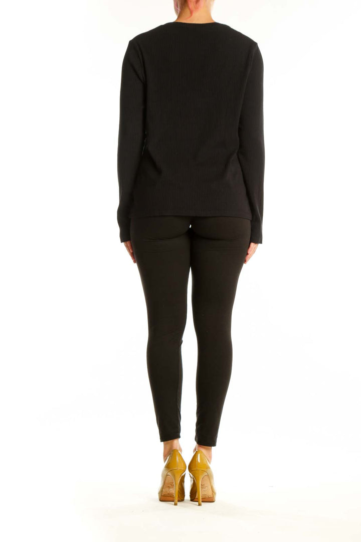 Black ribbed knit long sleeve top, back view on model wearing black leggings
