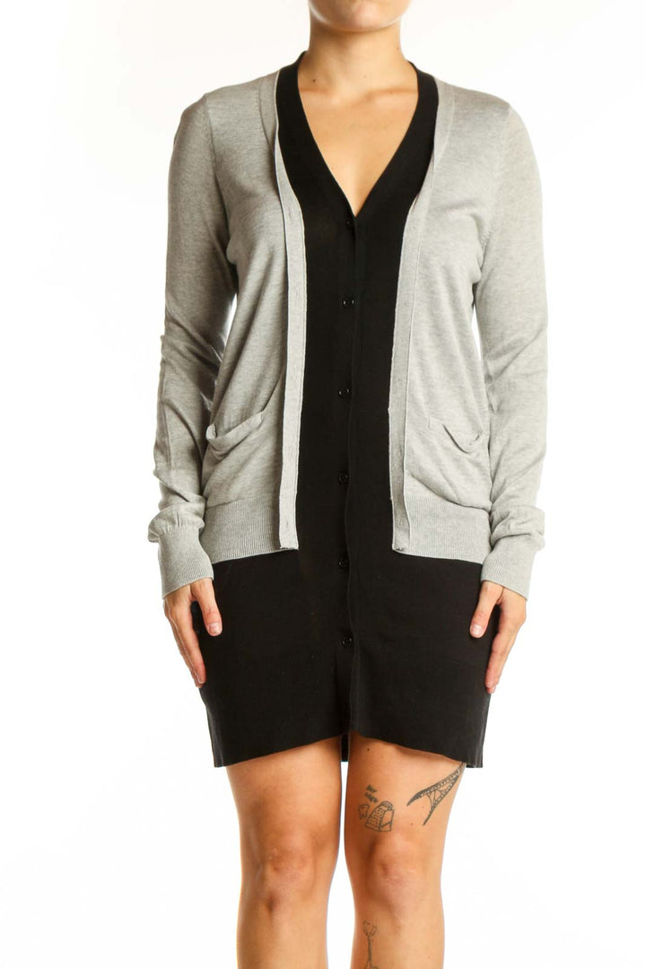 Gray and black BCBG MaxAzria cardigan with button-front closure and pockets, worn on model from front view