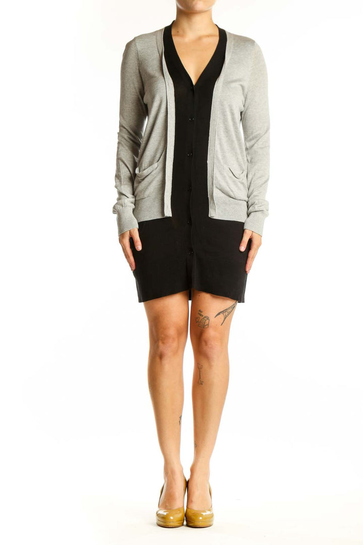 Gray and black BCBG MaxAzria cardigan with button-front closure and pockets, worn on model from front view