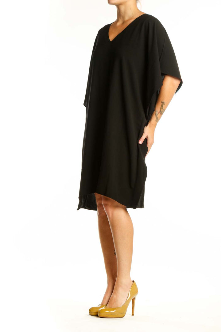 Black V-neck caftan dress with flutter sleeves, front view on model