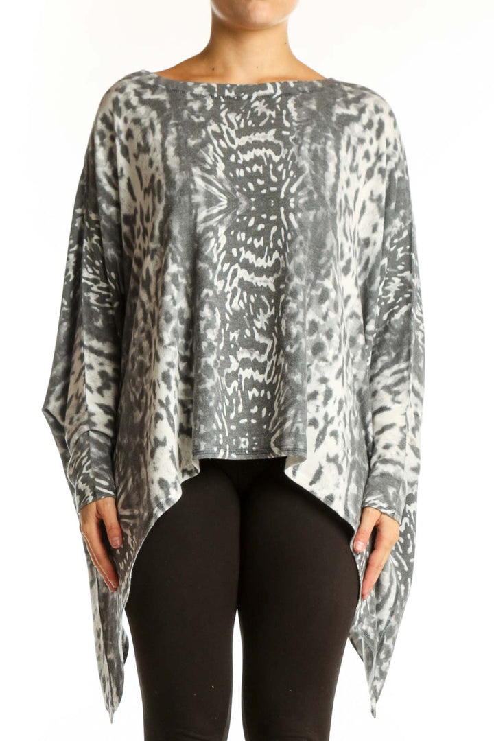Gray and cream animal print asymmetrical knit top with long sleeves and oversized fit, front view
