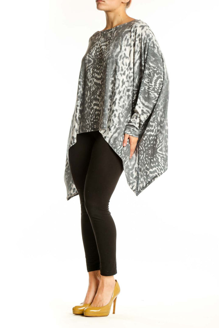 Gray and cream animal print asymmetrical knit top with long sleeves and oversized fit, front view