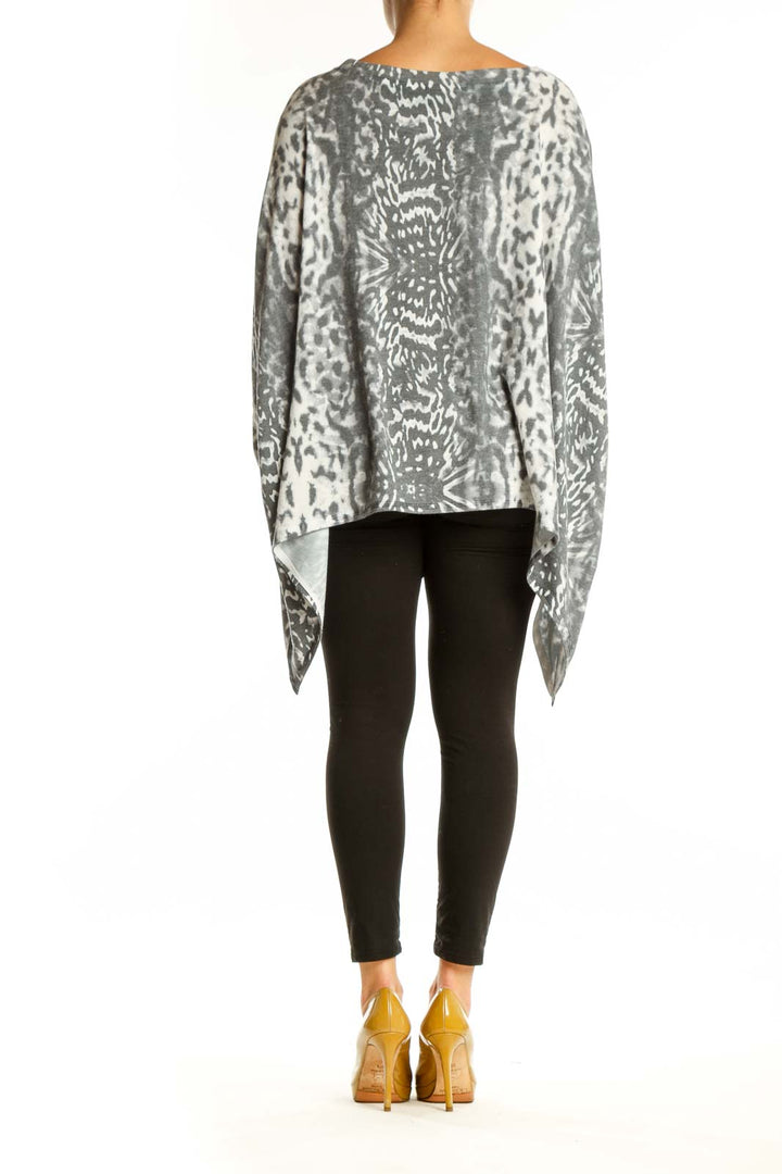 Gray and cream animal print asymmetrical knit top with draped hemline, back view