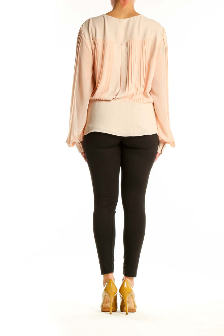 Cream wrap blouse with long sleeves and tie-waist detail, back view