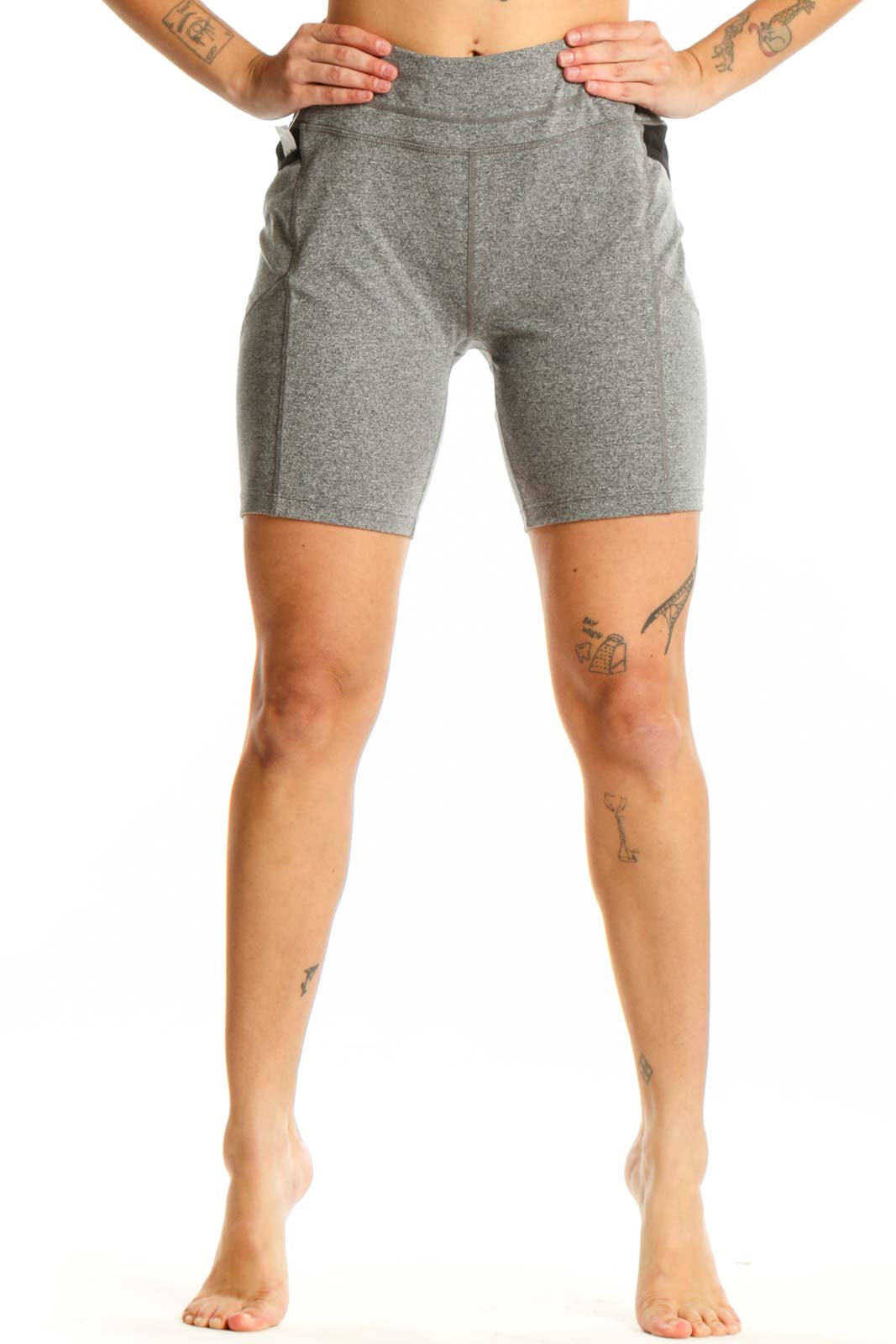 Front view of gray polyester Athleta bike shorts with high-waisted design and side pockets on model