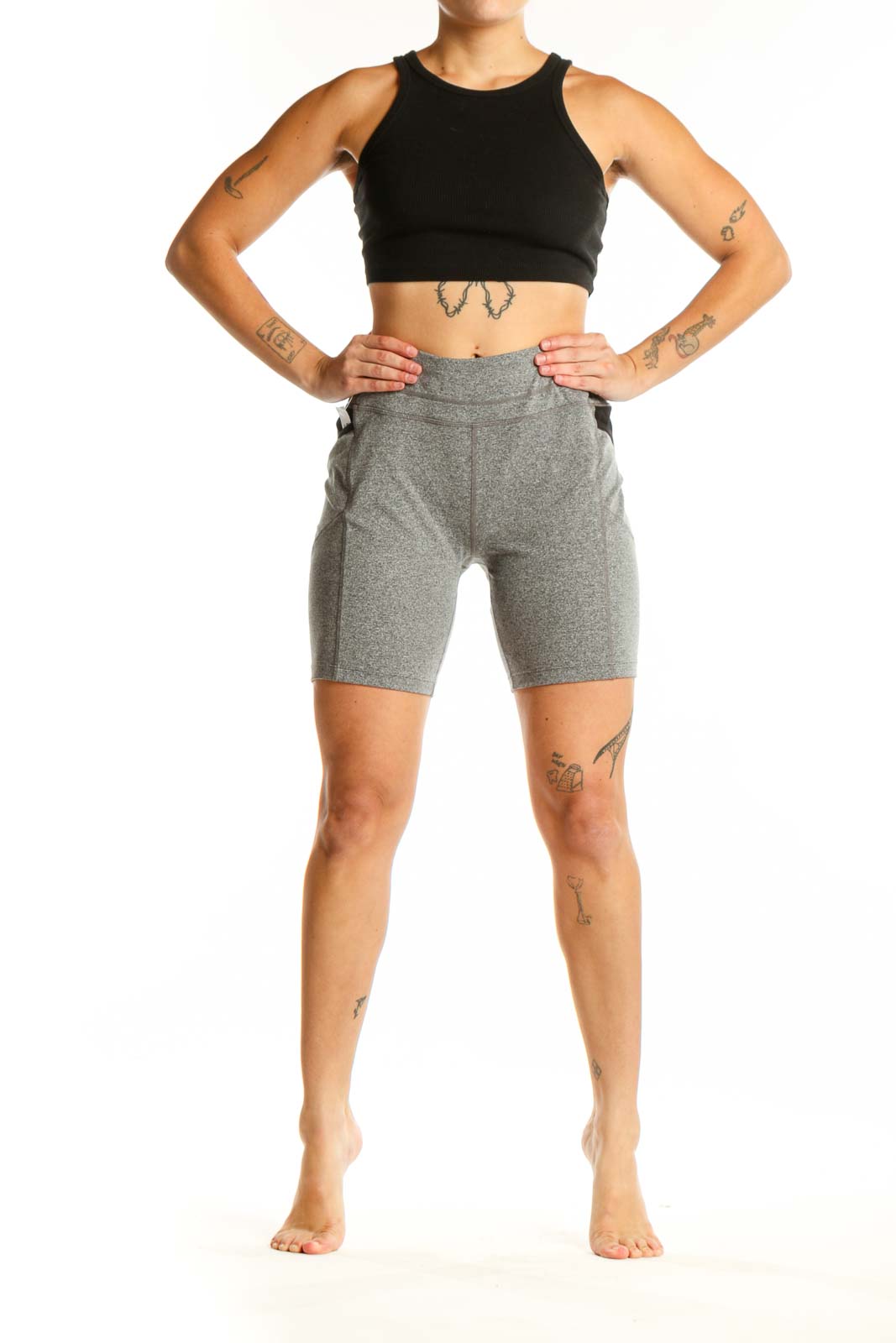 Front view of gray polyester Athleta bike shorts with high-waisted design and side pockets on model