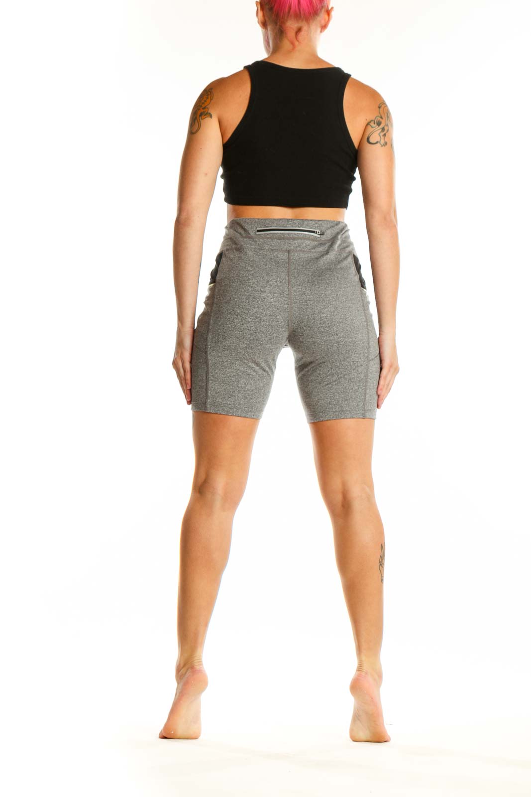 Back view of gray polyester Athleta bike shorts showing fit and design details