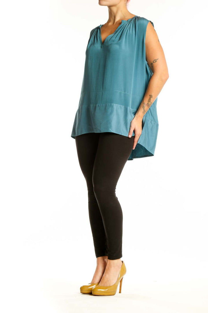 Teal sleeveless top with V-neckline and ruched shoulders, front view on model
