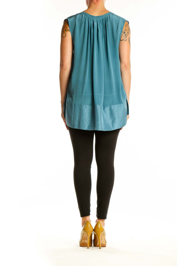 Teal sleeveless top with tiered hem detail, back view on model