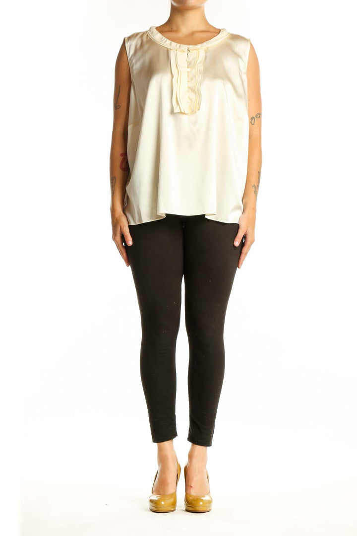 Cream silk sleeveless top with ruffle neckline detail, front view on model