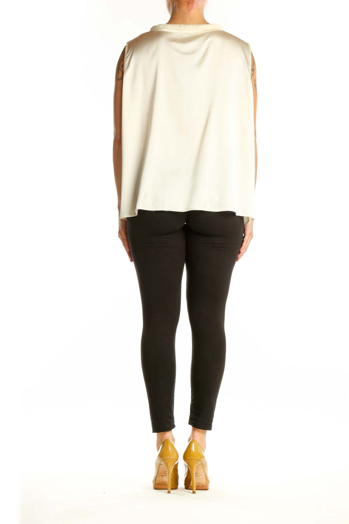 Cream silk sleeveless top back view, showing relaxed fit and center placket detail